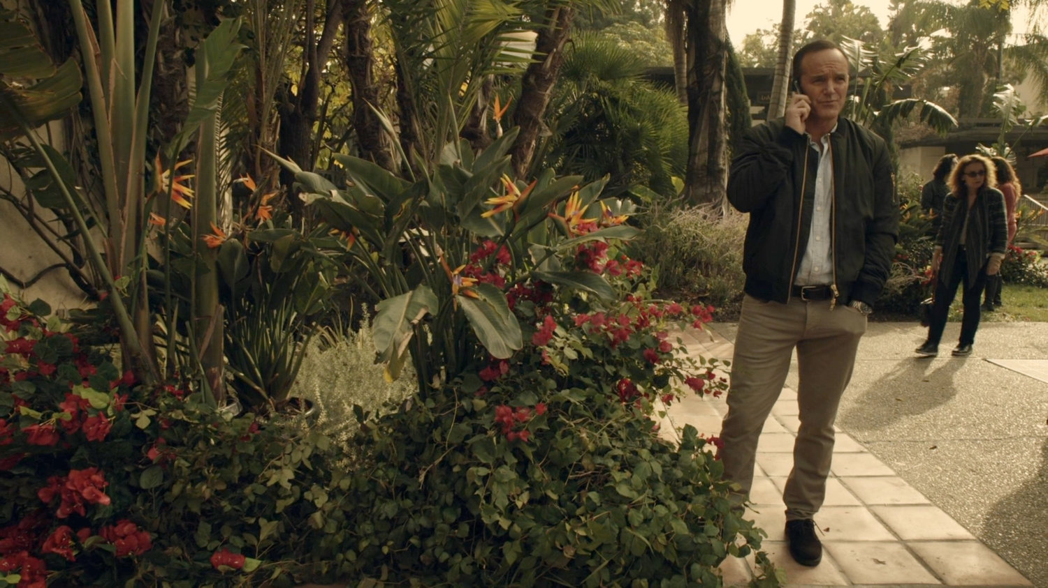 Coulson on phone in a Spanish plaza.