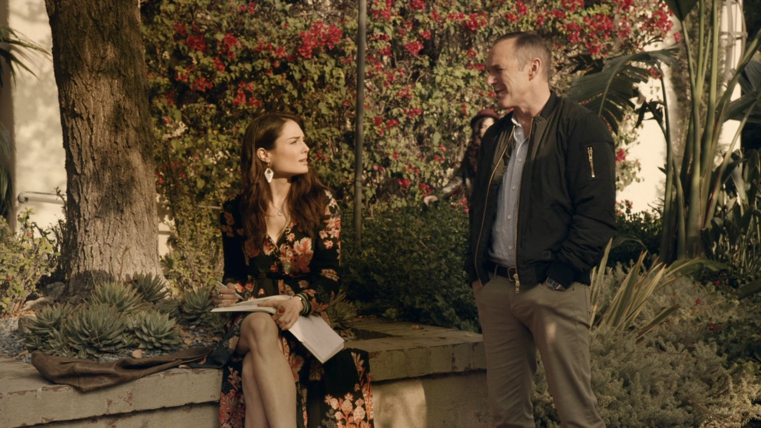Coulson talks with Agnes in Spanish plaza.