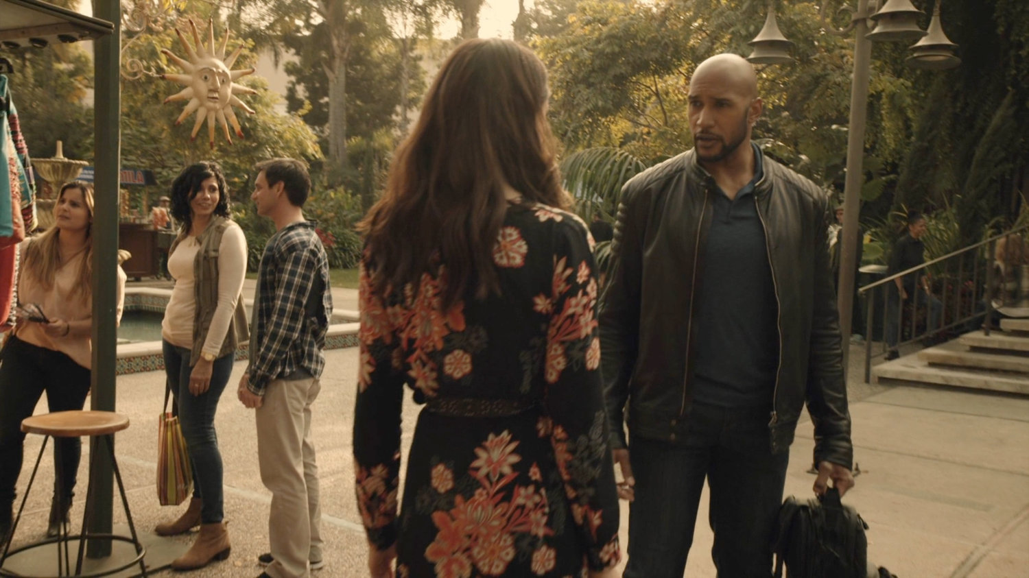 Mack talks with Agnes in Spanish plaza.
