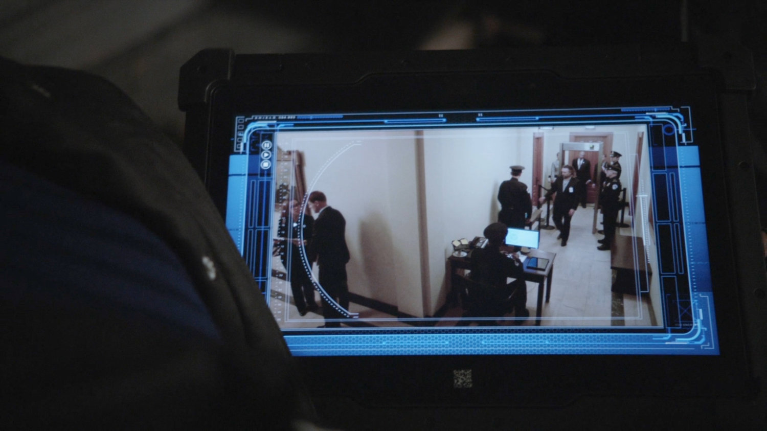 Video screen of security footage in Senate hallway.