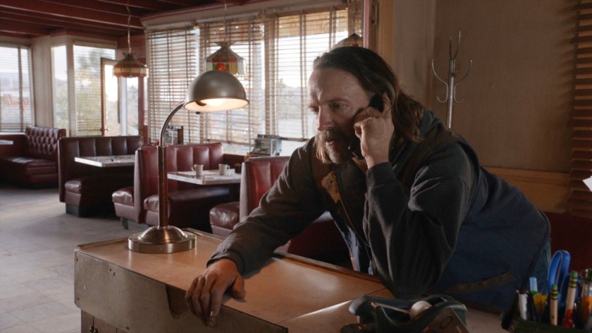 Shockley on phone in Park Mesa Motel diner.