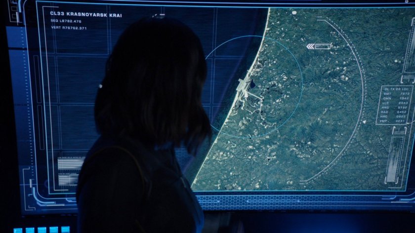 Daisy looking at screen showing satellite image of a SVR/submarine base.