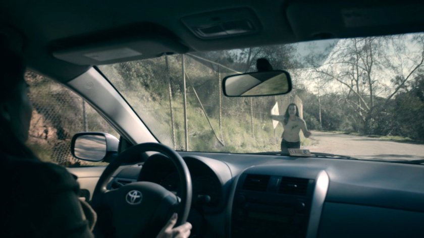 Simmons flags down a woman in a car outside the SHIELD Academy grounds in the Framework.