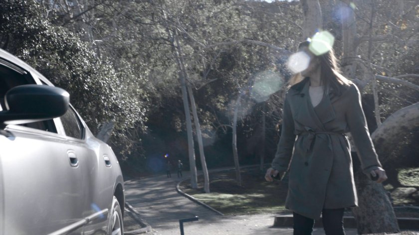 Jemma walking to her car in a park in the Framework