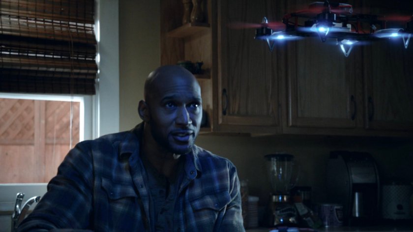 Mack looking at a drone in his kitchen inside the Framework.