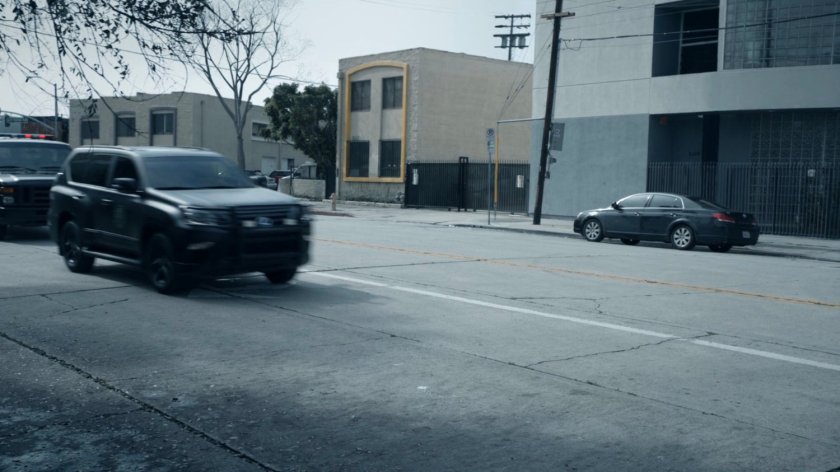 HYDRA Vehicles approach a bus stop on a street corner of the Framework.