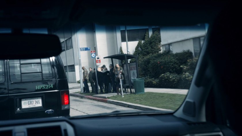 HYDRA vans pull up outside a bus stop on a street corner of the Framework.