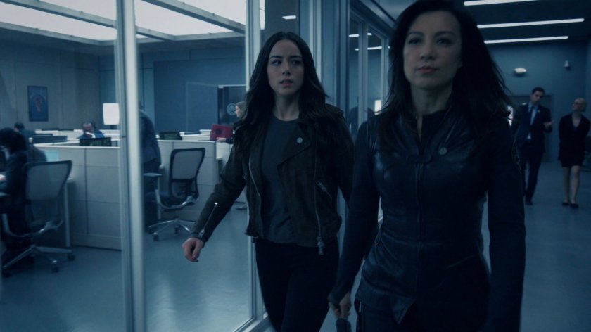 Daisy and May walk the hallway outside the bullpen of the Framework Triskelion.
