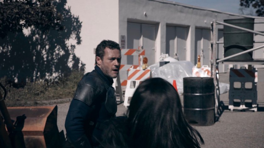 May fights the Patriot in a lot at the HYDRA Enlightenment Cultivation Center in the Framework.