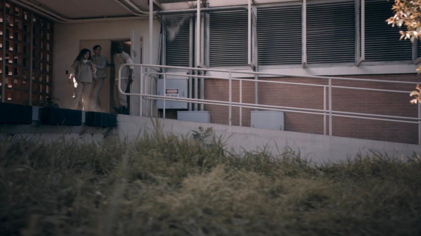 Tripp escorts prisoners out of the HYDRA Enlightenment Cultivation Center Isolation Unit in the Framework.