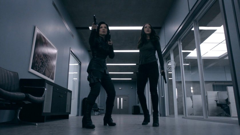Daisy and May walk the hallway outside the bullpen of the Framework Triskelion.