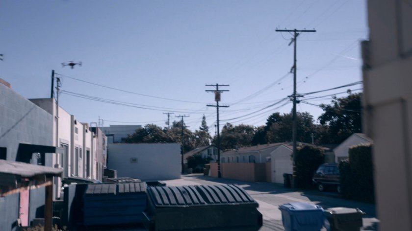 A drone hovers above an alley in the Framework.