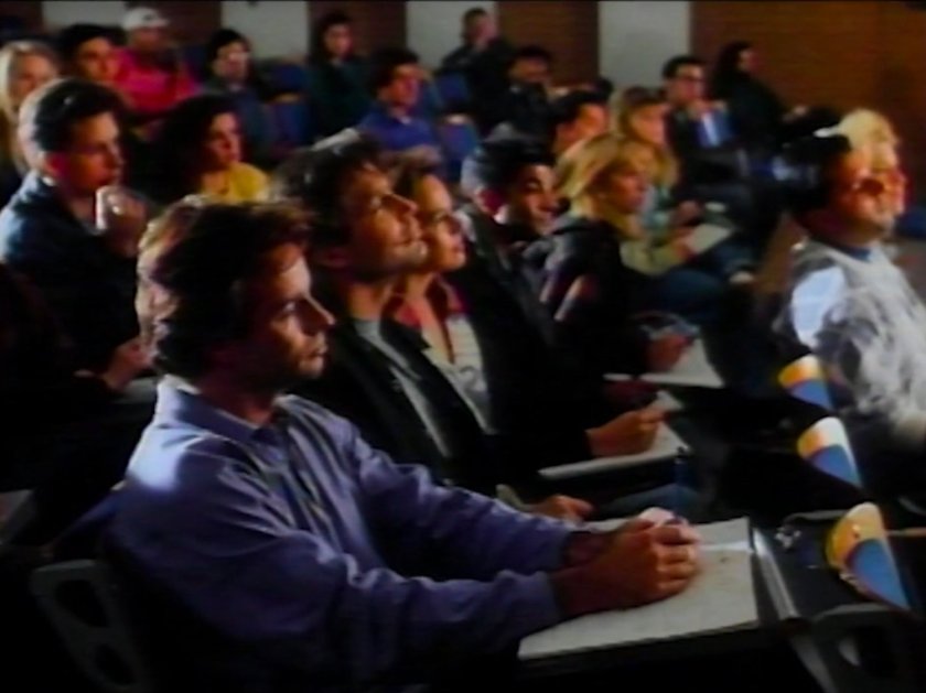 Reed in a college classroom with other students.