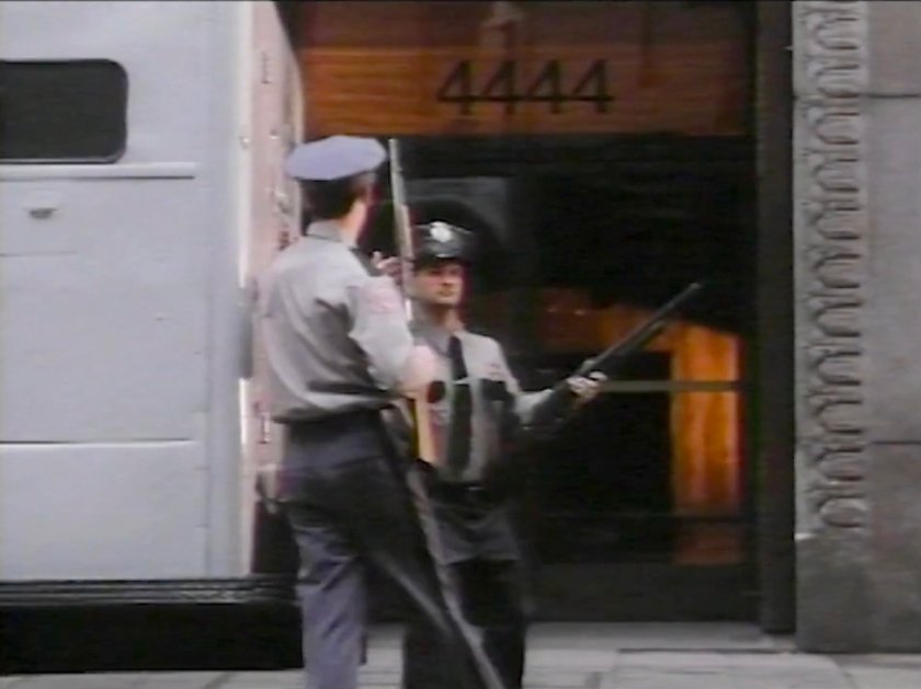 Armored car and two guards in front of the Baxter Building.