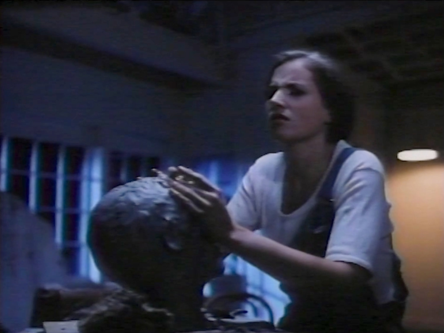 Alicia Masters sculpting a clay head in her loft.