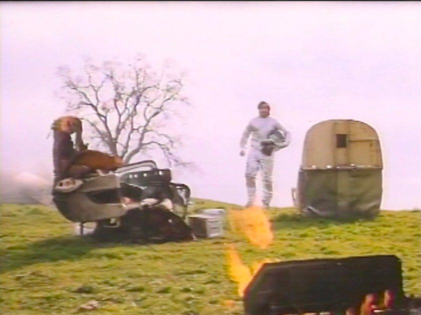 Ben walking through wreckage on a hill.