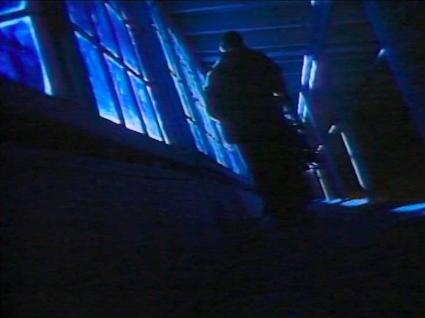 Silhouetted person on the catwalk in Alicia's studio loft.