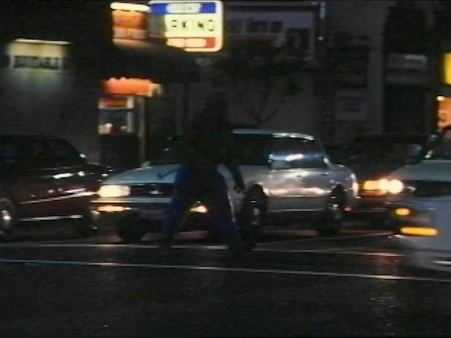 The Thing crossing a street at nighttime.