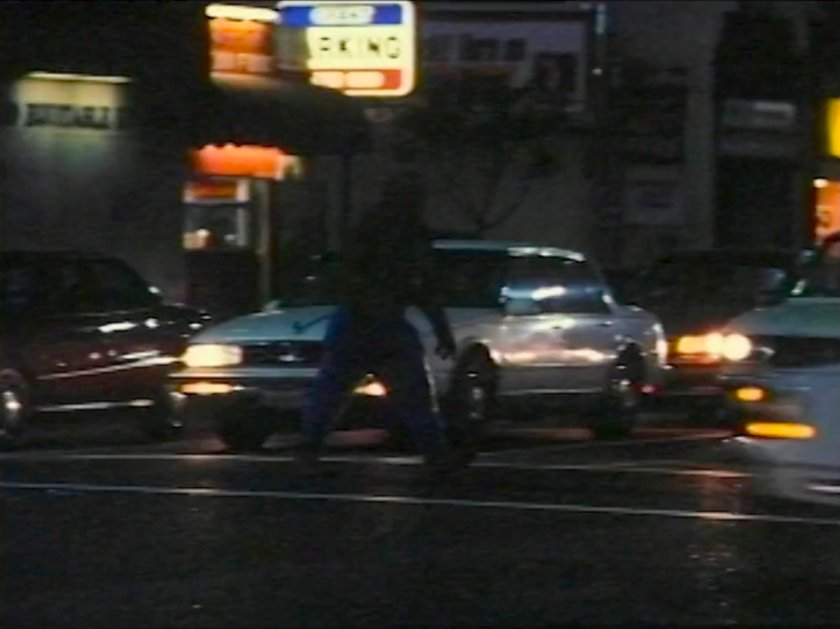 The Thing crossing a street at nighttime.