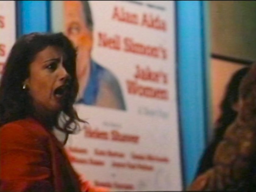 A woman startled by the Thing outside a theater.