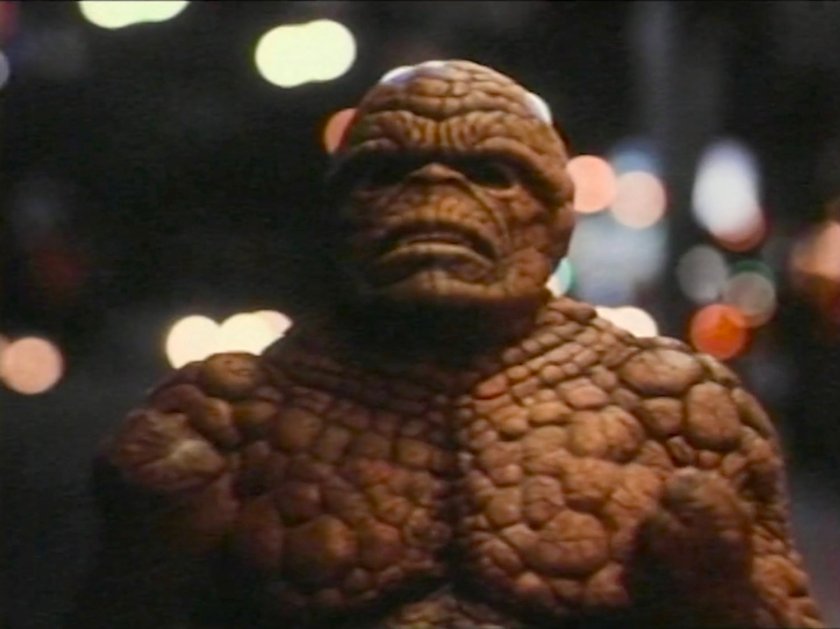 The Thing on a sidewalk at night.