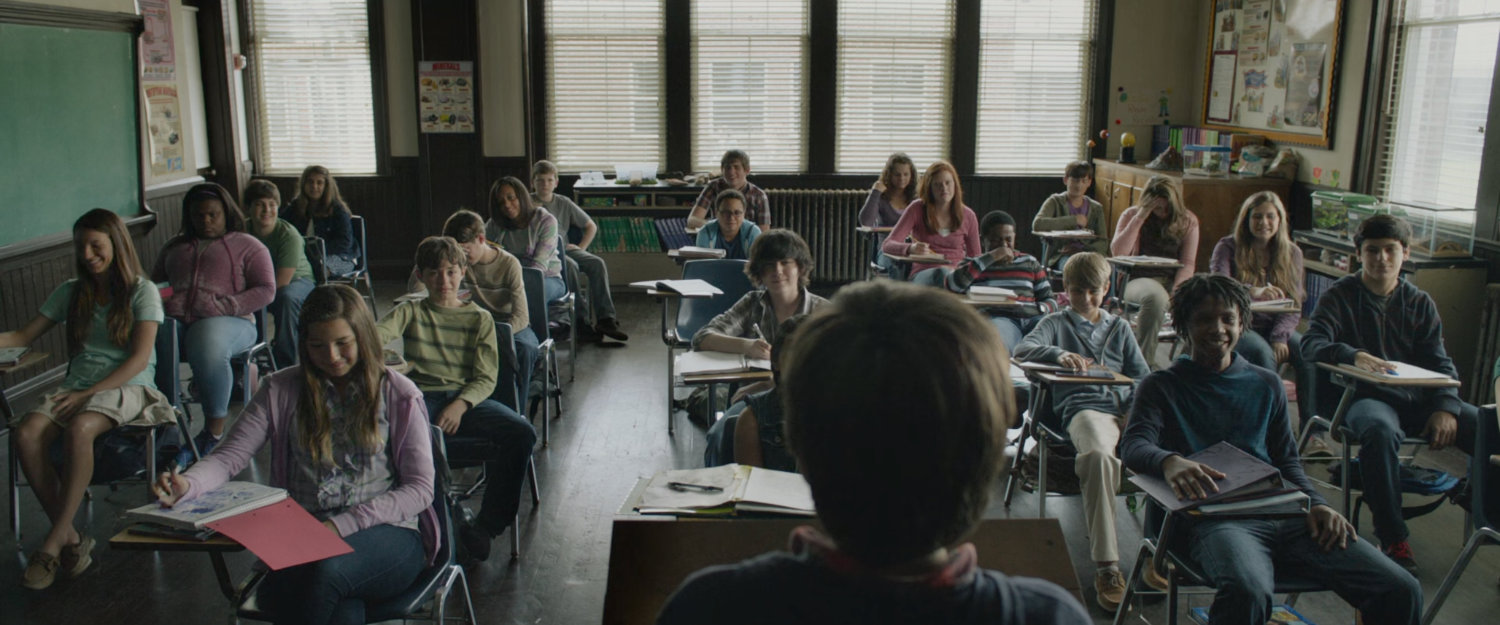Young Reed and other students in an elementary classroom.