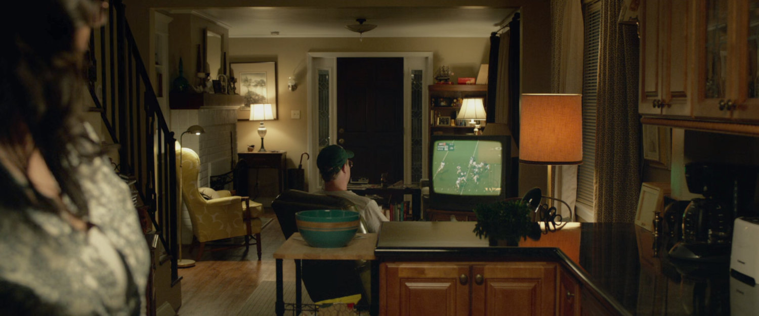 Mr Richards watching television in his house.