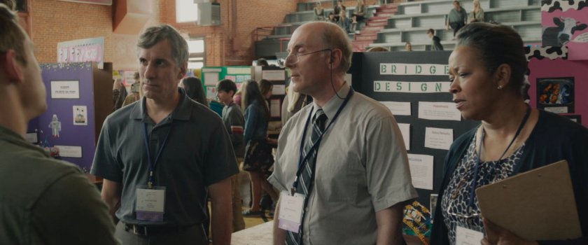 Teachers judging projects in the Nassau County Science Fair in a school gymnasium.