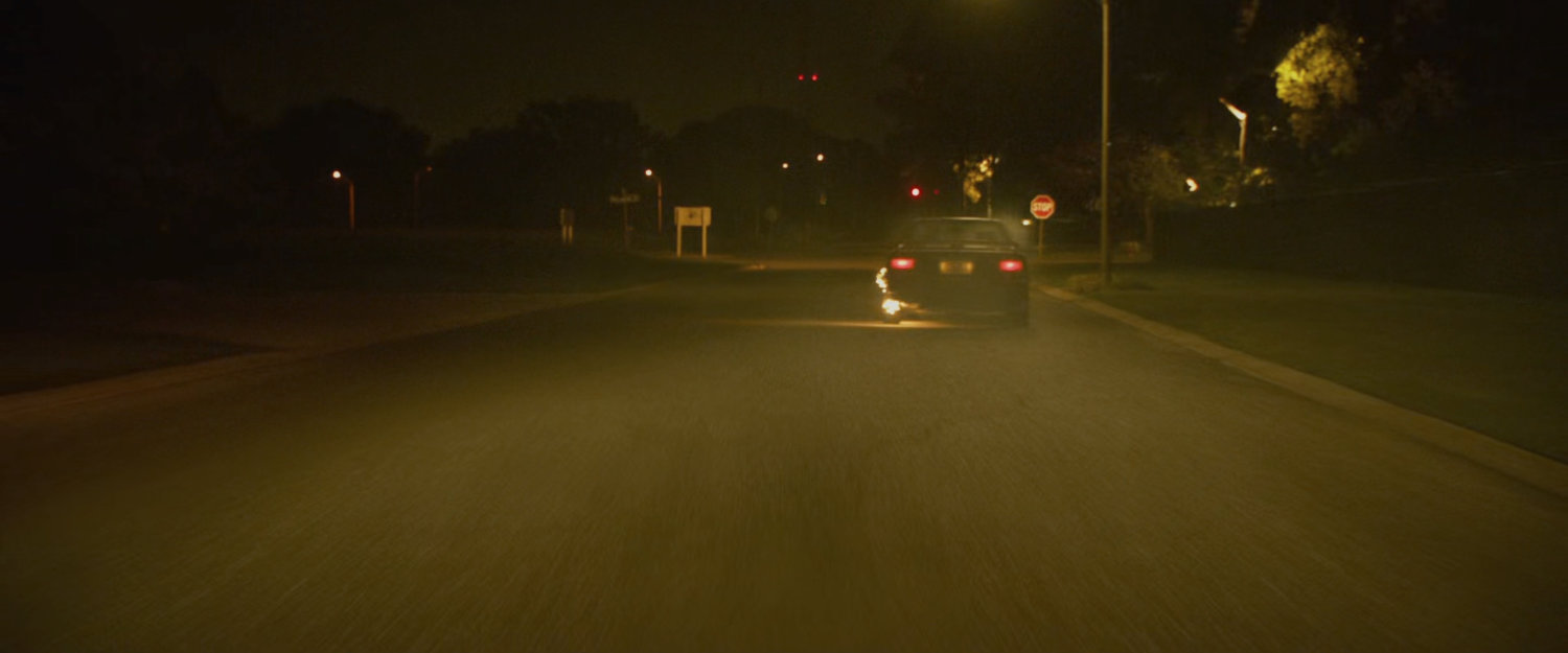 Car flaming out during street race.