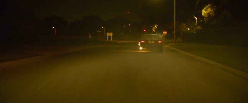 Car flaming out during street race.