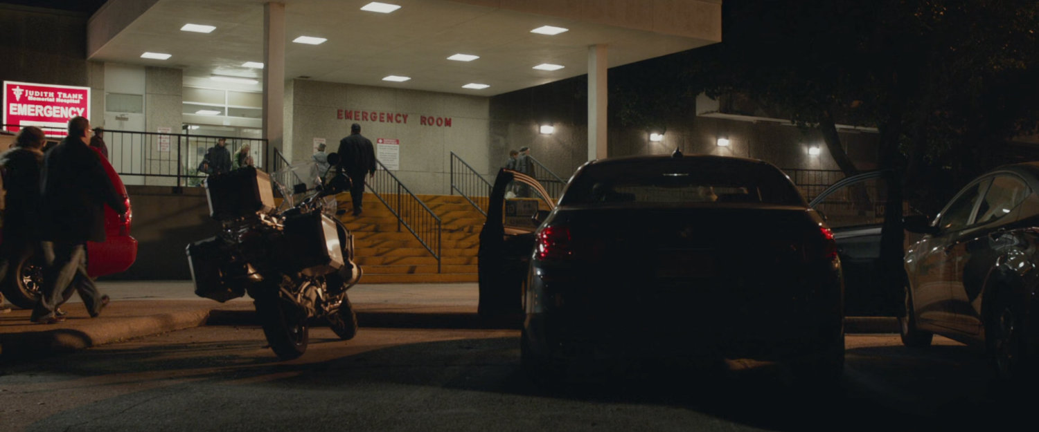 Cars and people outside the emergency room.