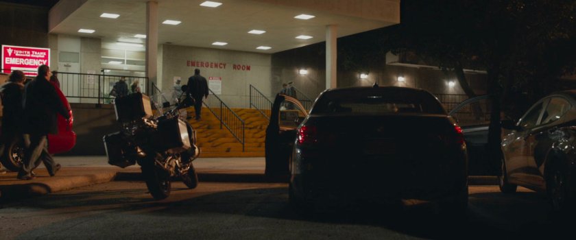 Cars and people outside the emergency room.