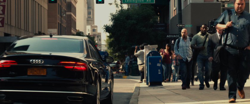 Car pulling up to sidewalk in Manhattan.