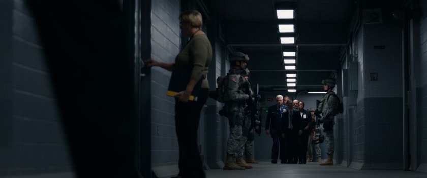 Army and staff in the hallway of Area 57.