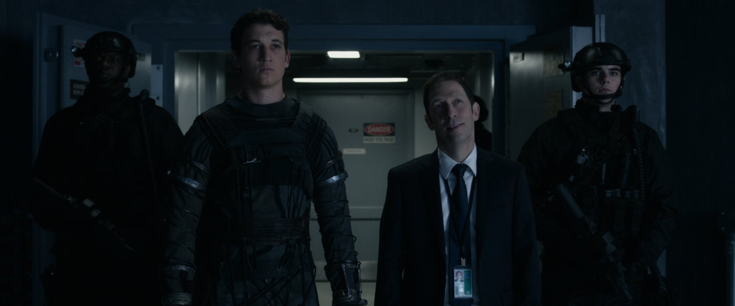 Reed and Dr Allen in a hallway of Area 57.