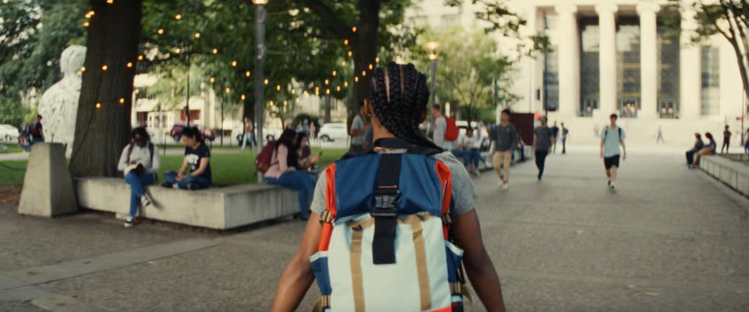 Riri walking through MIT quad.