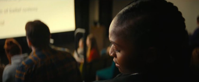 Riri sitting in a crowded MIT classroom.