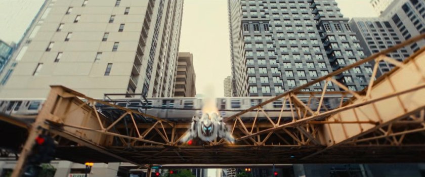 Ironheart flying past an elevated train in Chicago.