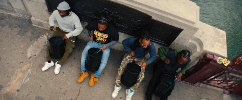 Four men drumming by a bridge in Chicago.