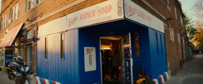 Riri walking past Mars Barber Shop in Chicago.