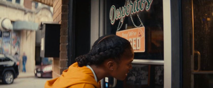 Riri looking in the window of Desperito's Pizza.