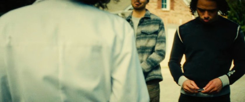 The Hood gives Clown his business car while John looks on.