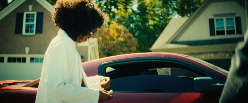 Clown stands outside her boyfriend's car.