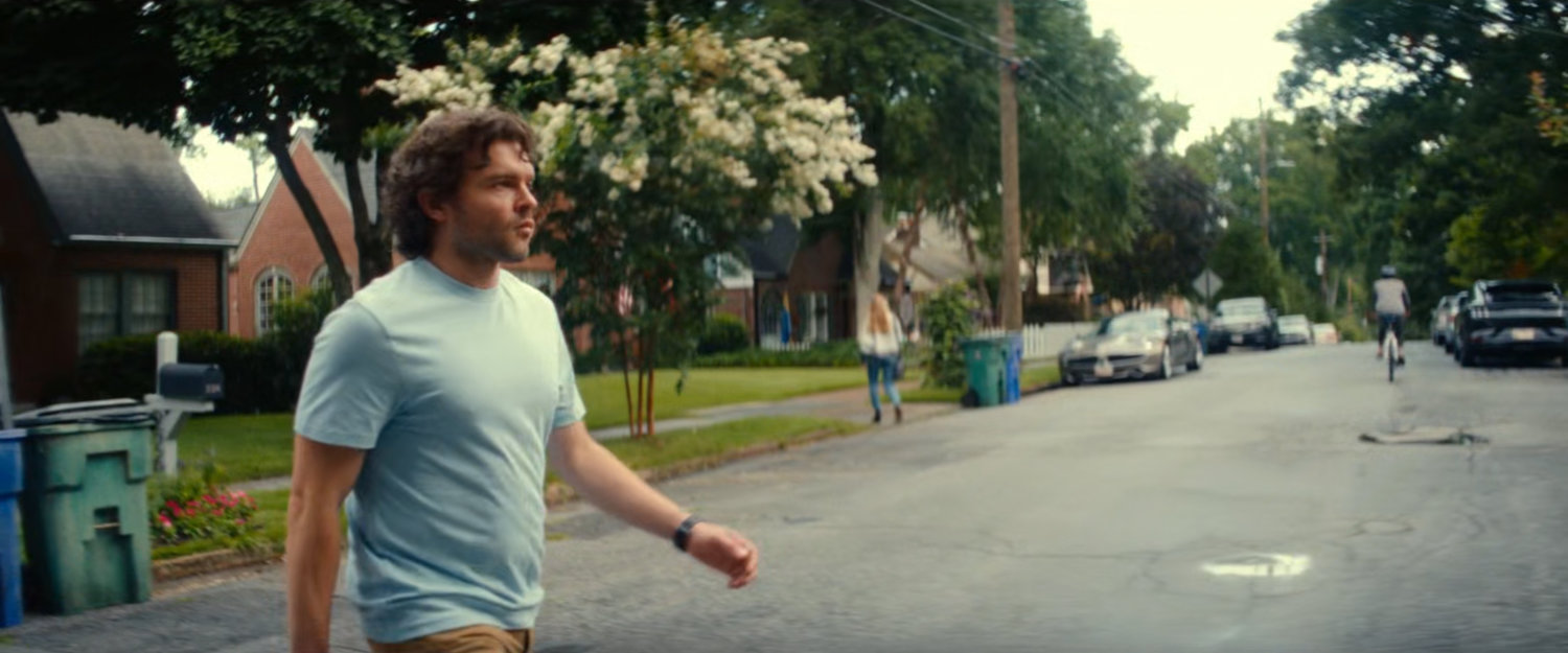 Joe crossing the street outside his house.
