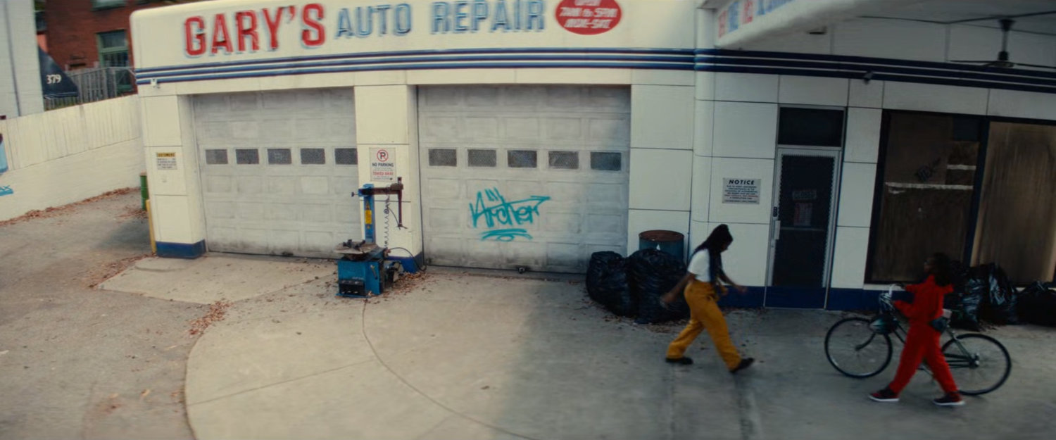 Riri and NATALIE outside Gary's Auto Repair.