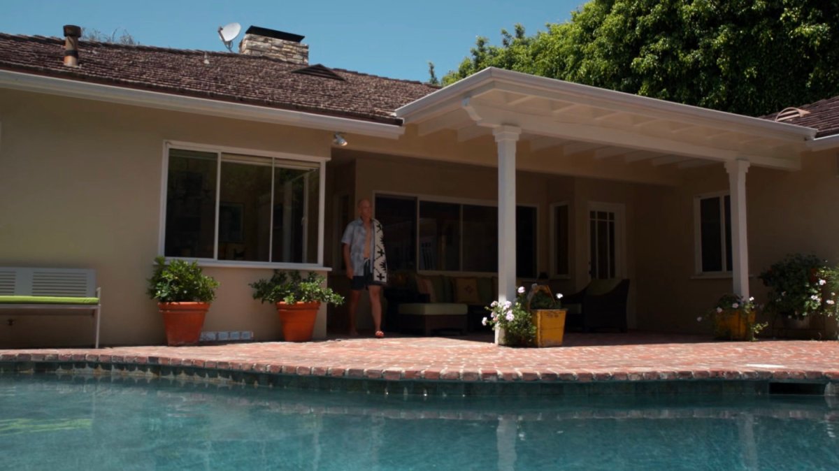 Enoch on his back patio by his pool.