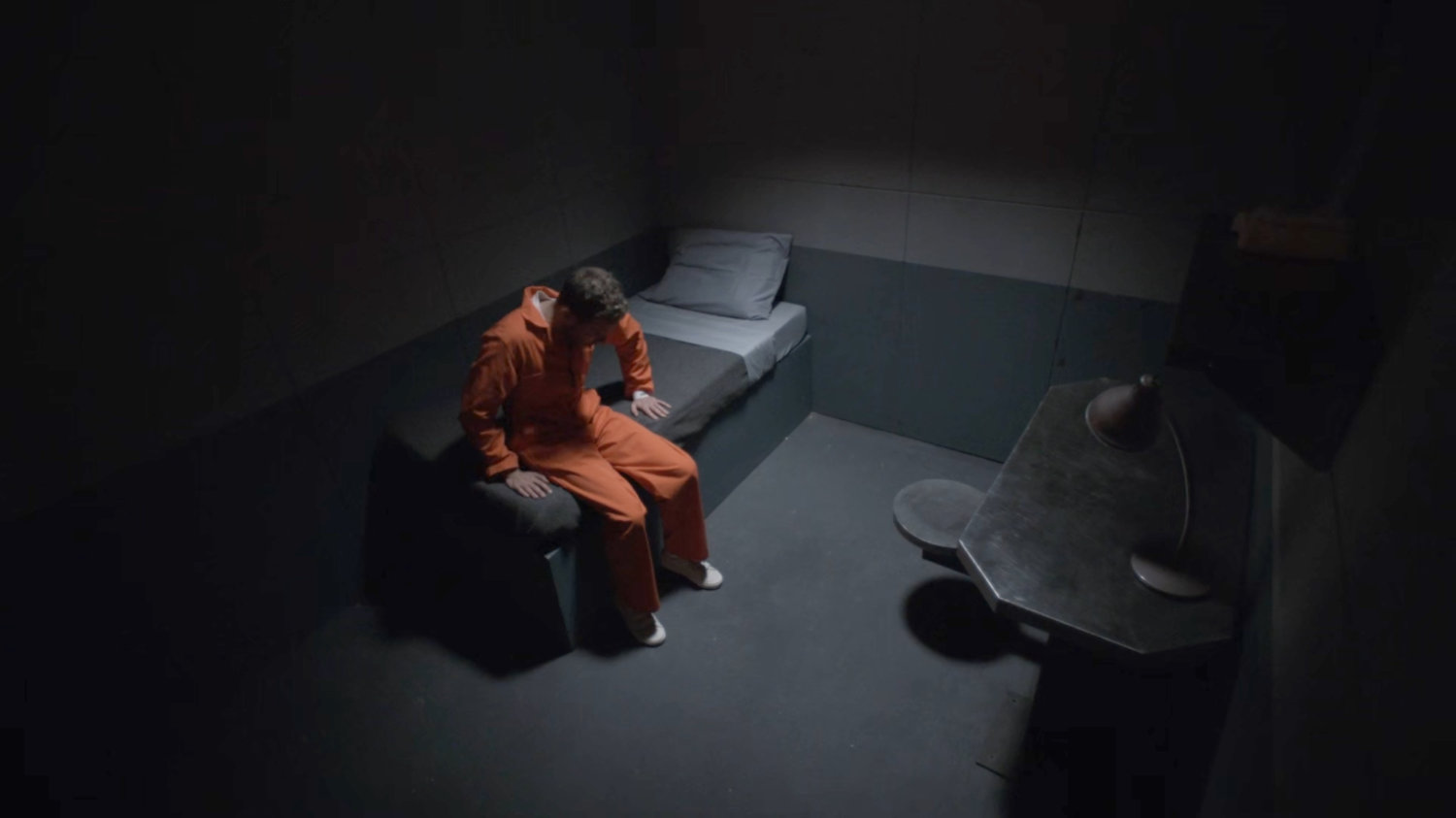 Fitz in a cell at a military base.