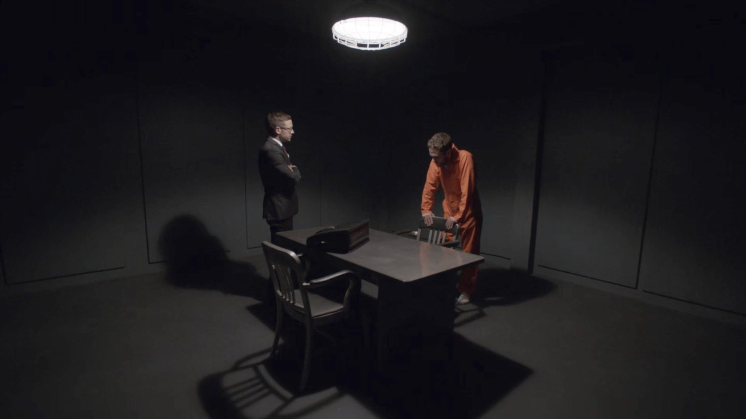 Hunter and Fitz in an interrogation room at a military base.