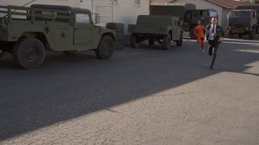 Hunter and Fitz running across a military base.