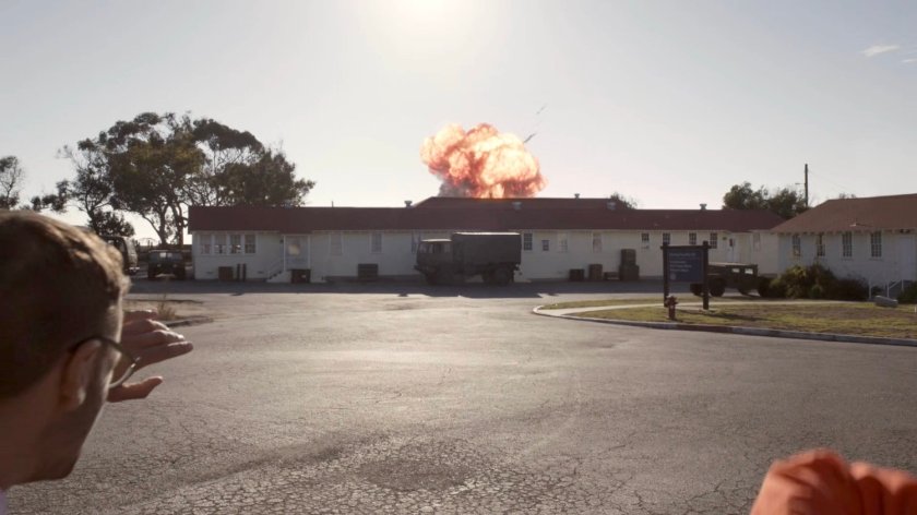 A helicopter crashes in a fireball at a military base.
